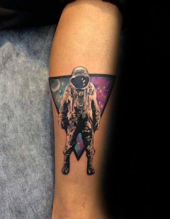 Black and grey astronaut tattoo with a colorful galaxy triangle background, inspired by Deja Entendu album artwork.