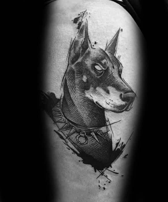 Sketch-style Doberman tattoo with sharp lines, ink splatters, and a spiked collar for a bold, artistic black and grey look.