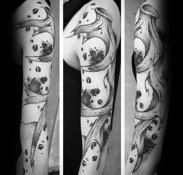 Abstract elk antler sleeve tattoo with bold black ink splashes and dynamic linework, creating a striking and artistic full-arm design.