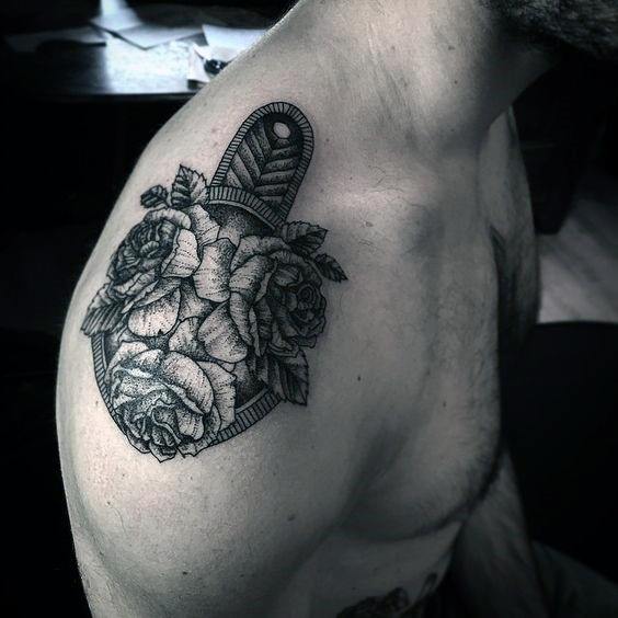 Shoulder epaulette tattoo with fine line detailing, featuring roses blooming over a textured military-inspired base.