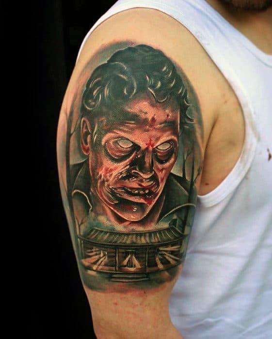 Realistic Evil Dead tattoo of a demonic face with glowing eyes and wounds, looming over the iconic haunted cabin in dark tones.