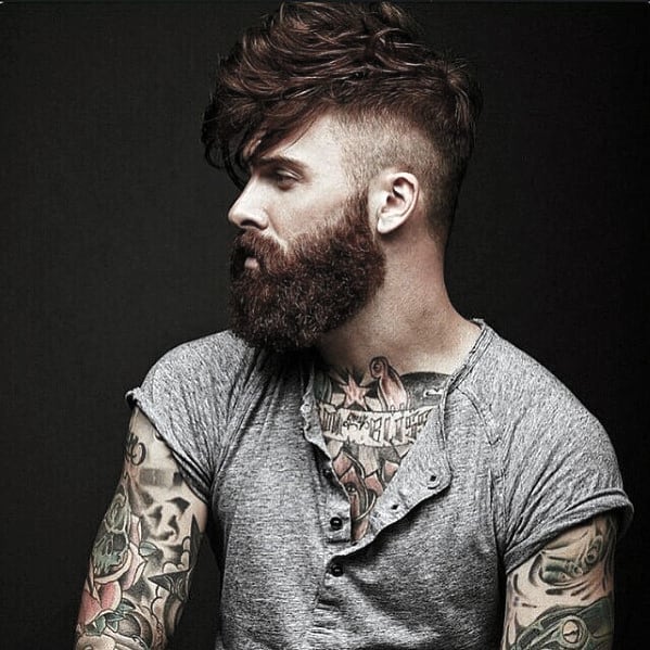 Ginger man with undercut hairstyle and medium length beard