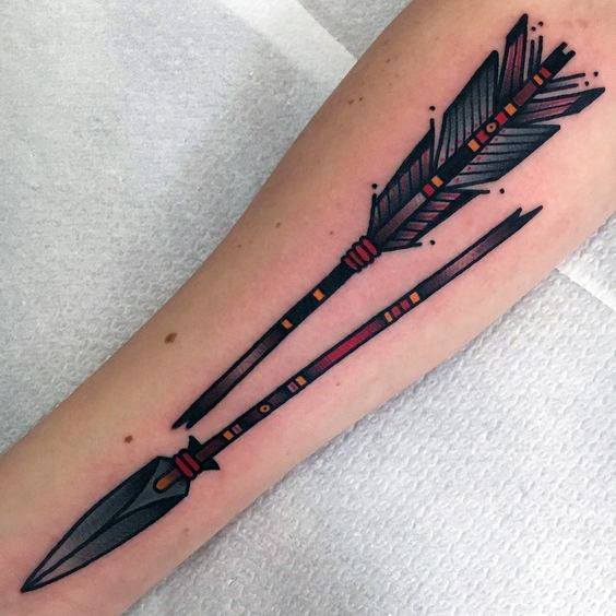 Broken arrow tattoo with tribal-inspired details in black and red, featuring bold lines and dot accents along the shaft and fletching.