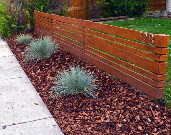 modern wood front yard fence bark chips 