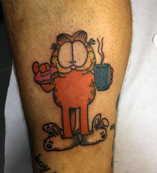 Garfield tattoo featuring him in bunny slippers, holding coffee and a donut—perfect for a fun and laid-back design with humor.