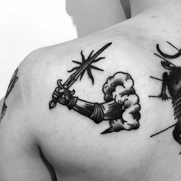 Black ink tattoo of a medieval armored gauntlet emerging from a cloud, holding a sword with a starburst spark at the tip.