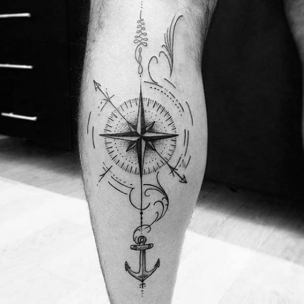 Geometric compass tattoo on calf with anchor, arrow, and swirl accents, combining nautical and directional elements.