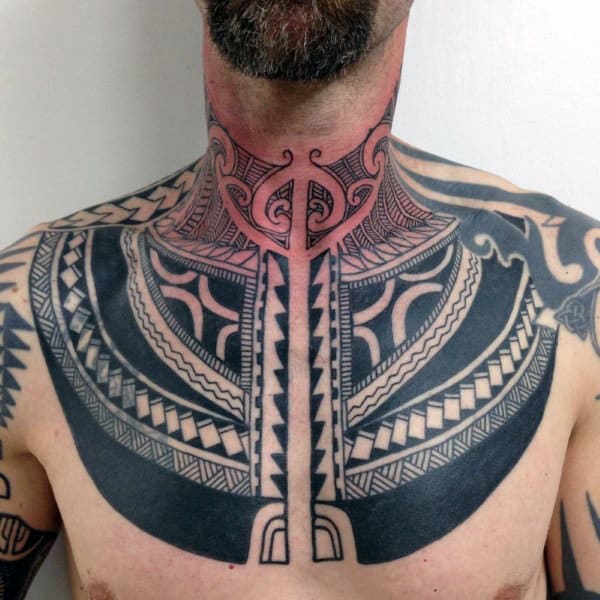 Bold geometric throat and chest tattoo with intricate tribal patterns, sharp lines, and symmetrical black ink detailing