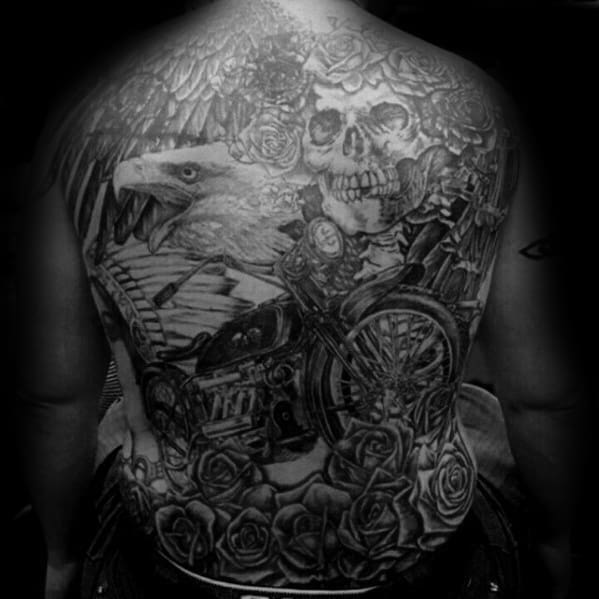 Grateful Dead full back tattoo with a skull and roses, a fierce eagle, wings, and a detailed motorcycle in black and grey style.