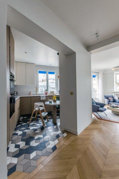 Tile-to-wood floor transition with geometric hexagon tiles blending into herringbone hardwood for a stylish modern look