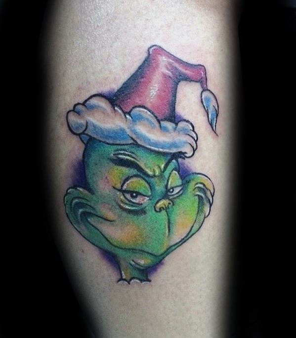 Colorful Grinch face wearing a Santa hat, with vibrant green, red, and purple hues, creating a playful and mischievous tattoo design.