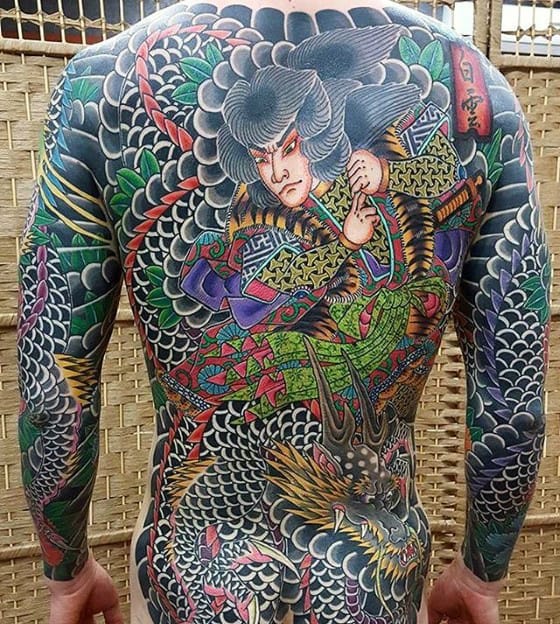 Man with detailed full-back traditional Japanese tattoo featuring a warrior and dragon