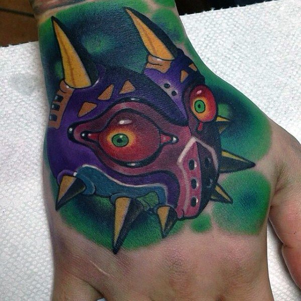 Awesome Hand Majoras Mask Tattoos For Men