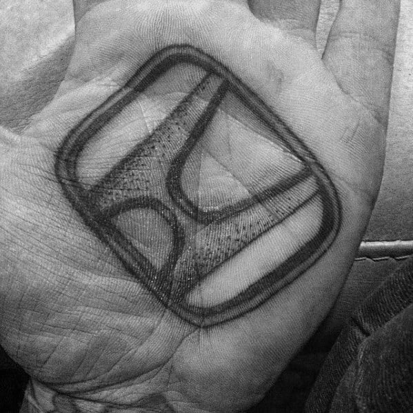 Honda logo tattoo on a man's palm, featuring a bold black and gray design with a three-dimensional effect.