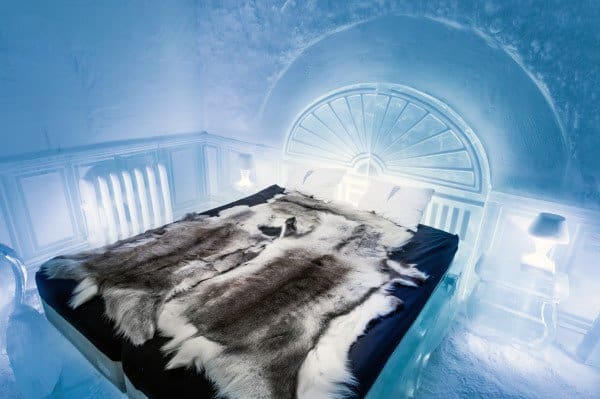 Frozen-themed bedroom with ice bed frame, fur bedding, and glowing ice decor.