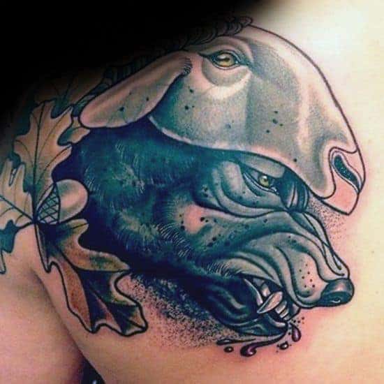 Tattoo of a wolf in sheep's clothing, with detailed shading, leaves, and acorns on a shoulder