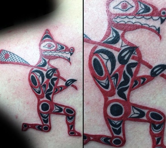 Tribal-style lacrosse tattoo featuring a warrior-like figure with bold black and red patterns, holding a lacrosse stick in a dynamic pose.