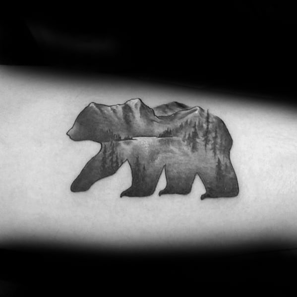 Bear-shaped lake tattoo with mountain and forest landscape inside, blending wildlife silhouette with serene nature scenery.
