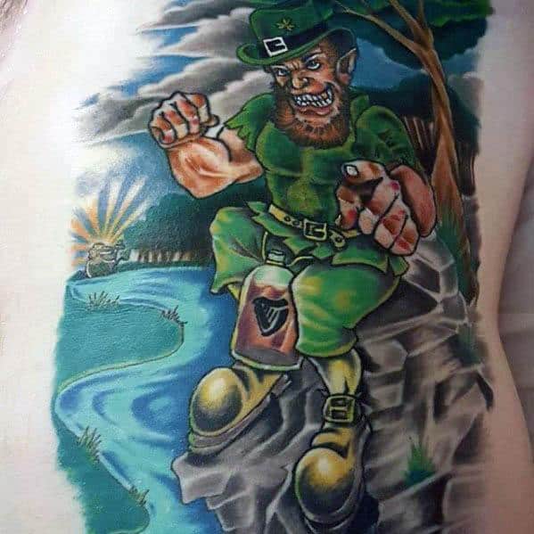 Colorful tattoo of an aggressive leprechaun in a fighting stance, sitting on a rock by a river with a Guinness keg leg and scenic forest background.