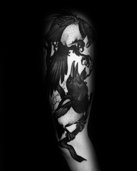 Dark black and gray magpie tattoo sleeve featuring two birds interacting among twisting branches, with bold contrast and intricate shading for a dramatic look.