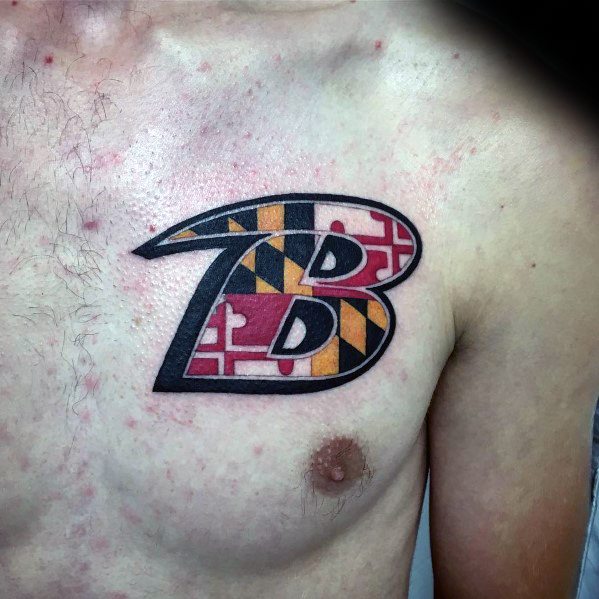 Baltimore Ravens-inspired tattoo on the chest, featuring the team’s "B" logo filled with the bold colors and pattern of the Maryland flag.