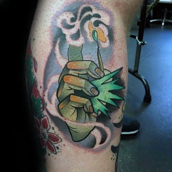 Colorful tattoo of a stylized hand holding a lit match with bold smoke and burst effect, symbolizing power, ignition, and creative energy.