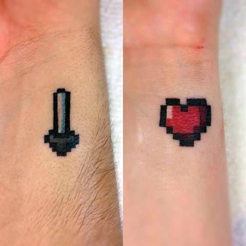 Matching Minecraft tattoos on wrists: one features a black pixelated sword, the other a red pixelated heart with a black outline.