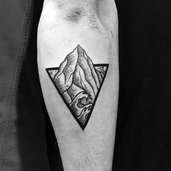 Black ink tattoo of a mountain and wave enclosed in an inverted triangle, combining bold linework and nature-inspired elements in a geometric design.