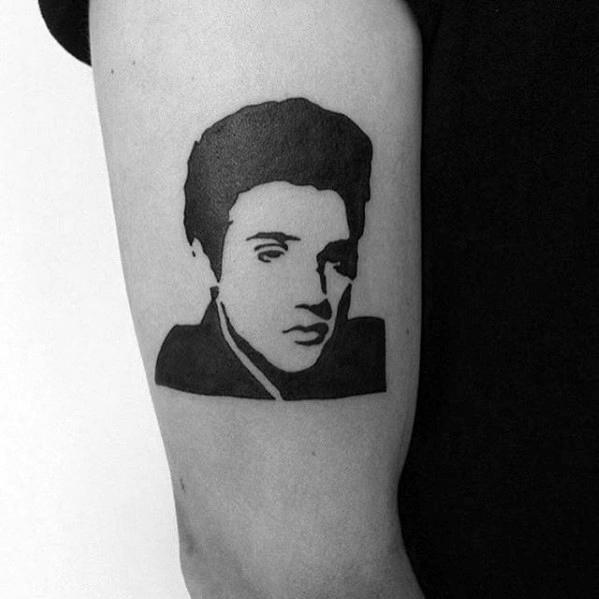 Minimalist Elvis Presley tattoo in solid black silhouette style, featuring his iconic hair and piercing gaze.