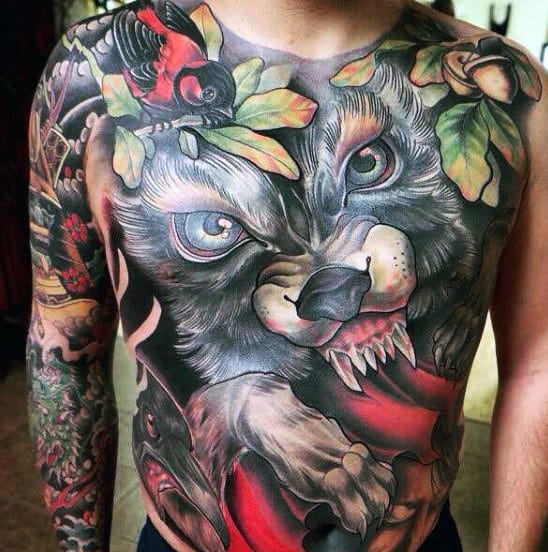 Neo-traditional full chest tattoo of a snarling wolf with piercing blue eyes, autumn leaves, a red cape, and bold shading for a dramatic effect.