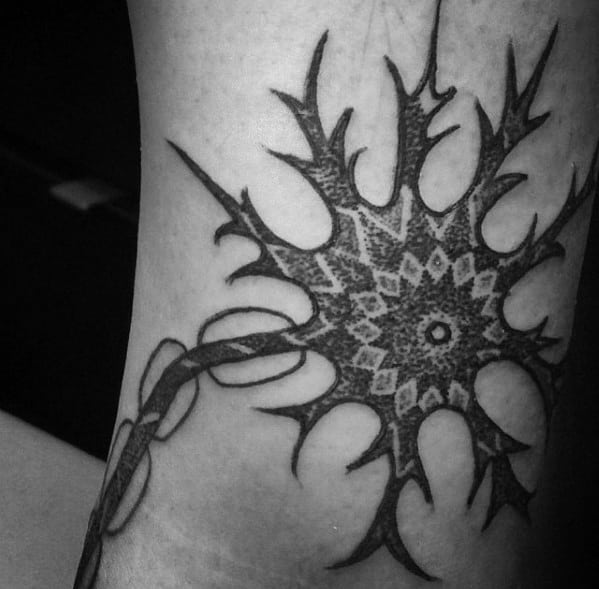 Black ink neuron tattoo with geometric mandala-style cell body and bold, spiky dendrites along the arm.