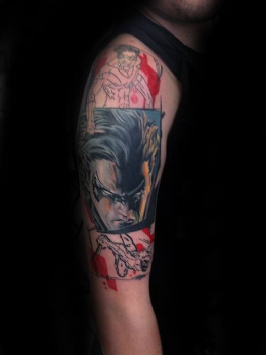 Comic-style Nightwing tattoo featuring dynamic portraits and action poses in red, black, and skin-tone shades on the upper arm.