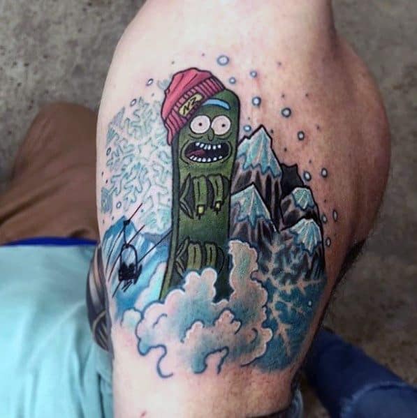 Pickle Rick tattoo in a snowy mountain scene, wearing a beanie with a fun, colorful design featuring clouds, a ski lift, and icy peaks.