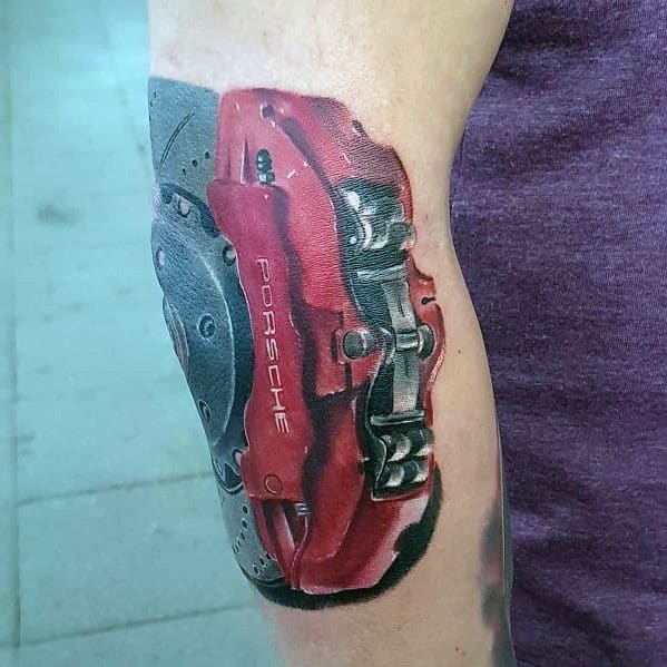 Realistic tattoo of a red Porsche brake caliper, perfect for men's automotive-inspired tattoo ideas.