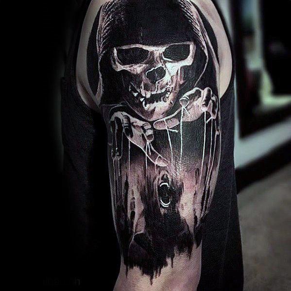 Dark puppet tattoo featuring a grim reaper figure controlling a screaming puppet with strings, symbolizing fear and fate.