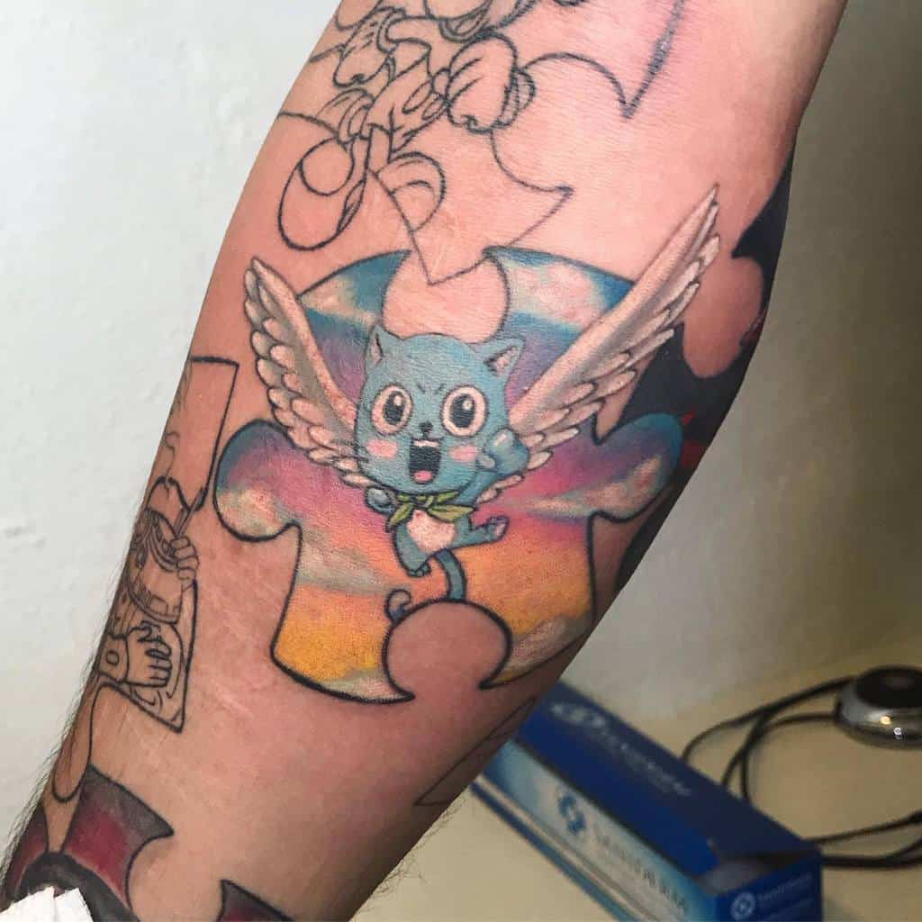 Colorful tattoo of Happy from Fairy Tail with wings, placed over a vibrant puzzle piece background, blending anime and symbolic elements.