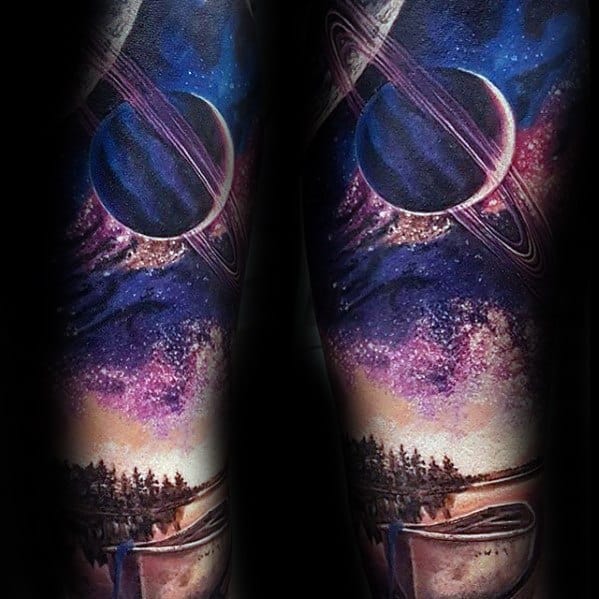 Vibrant Saturn tattoo design for men with a galaxy sky, lakeside forest, and canoe in rich purple, pink, and blue tones.