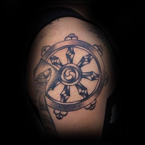 Awesome Shaded Dharma Wheel Upper Arm Tattoo For Guys