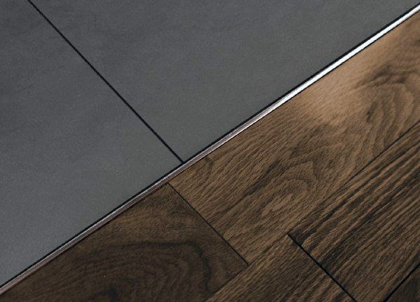 Tile-to-wood floor transition with a sleek stainless steel strip for a clean, modern finish