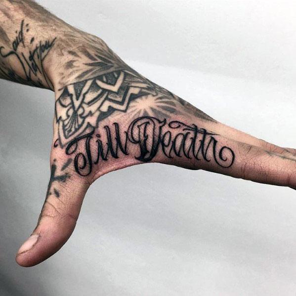 Side hand tattoo for men with elegant script reading Till Death, placed along the edge of the palm with surrounding black ink art.