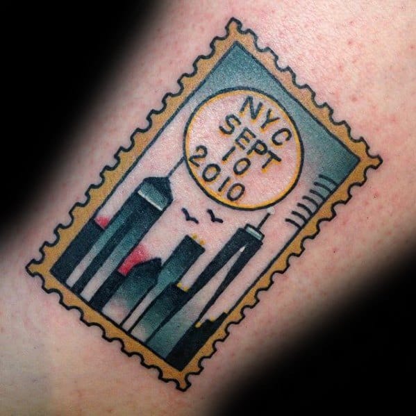 Postage stamp tattoo featuring the NYC skyline with "NYC Sept 10 2010" elegantly inscribed