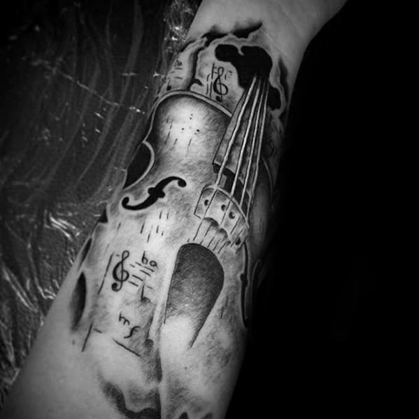 Realistic black and gray tattoo of a violin with musical notes, surrounded by abstract smoke-like shading, covering the forearm.