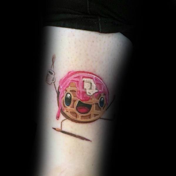 Cute animated waffle tattoo with a happy face, pink syrup, butter, and a coffee cup, bringing a fun and playful breakfast-inspired design.