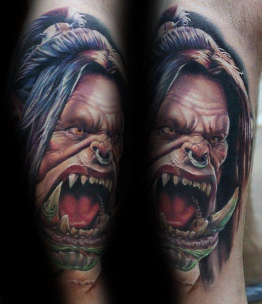 Realistic tattoo of a fierce orc from World of Warcraft, featuring intense details, sharp tusks, and glowing eyes, inked with vibrant colors.