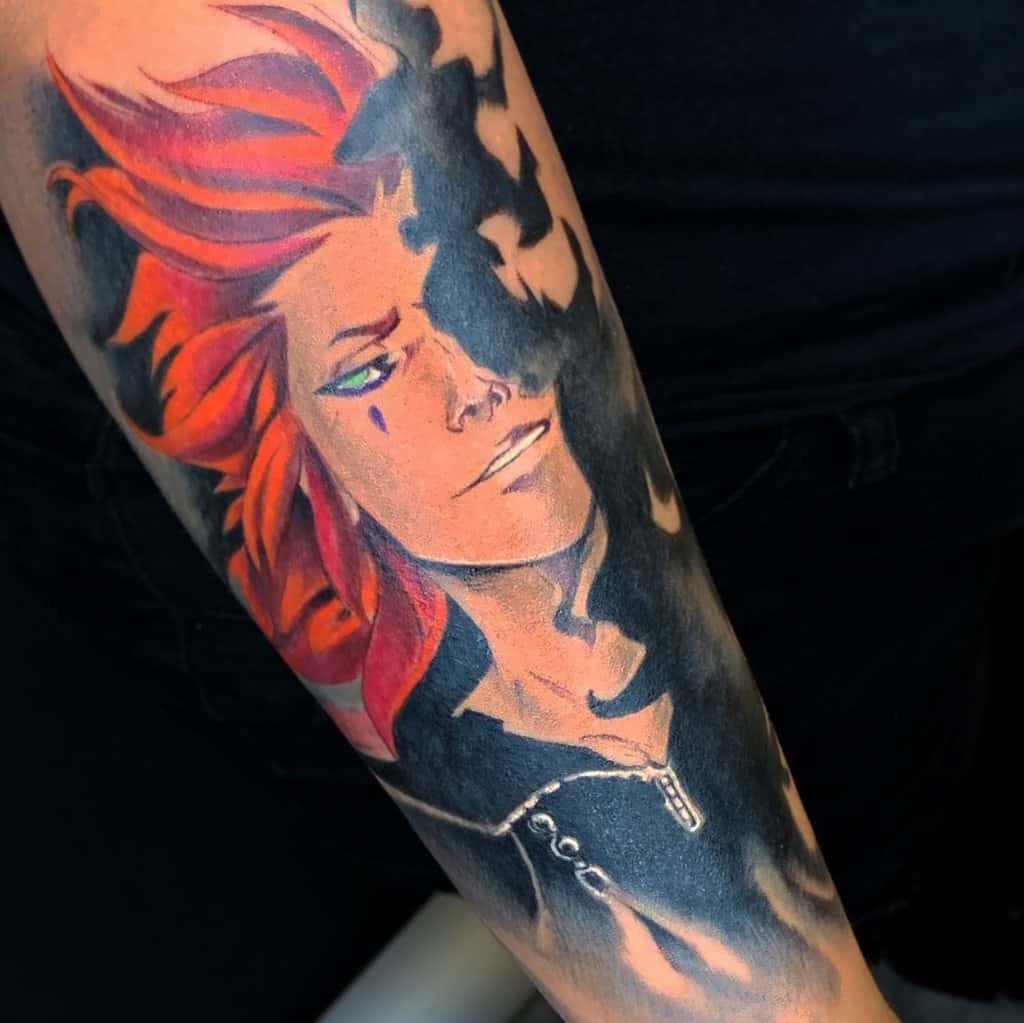 Kingdom Hearts tattoo of Axel with fiery red hair, a solemn expression, and dark shadows engulfing part of his face, blending into the background.