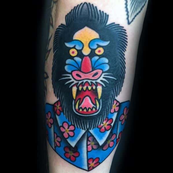 Traditional-style baboon tattoo with bold outlines, bright colors, and a playful twist featuring a floral Hawaiian shirt for a unique design.