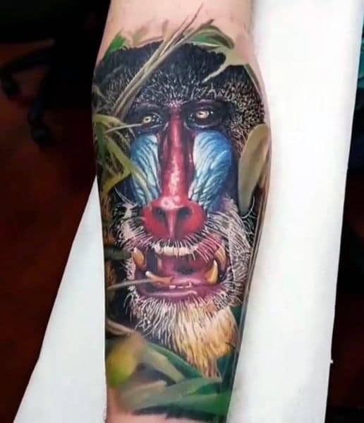 Hyper-realistic baboon tattoo with intricate fur details, vibrant facial colors, and jungle elements, creating a lifelike and dynamic sleeve design.