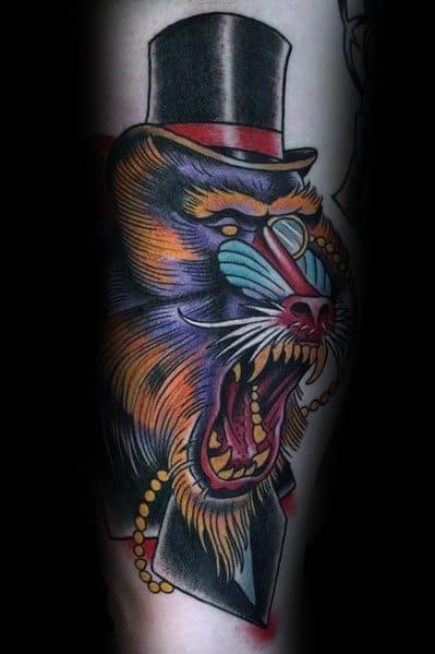 Neo-traditional baboon tattoo with bold colors, sharp details, and a unique twist featuring a top hat, monocle, and pearl necklace for a classy look.