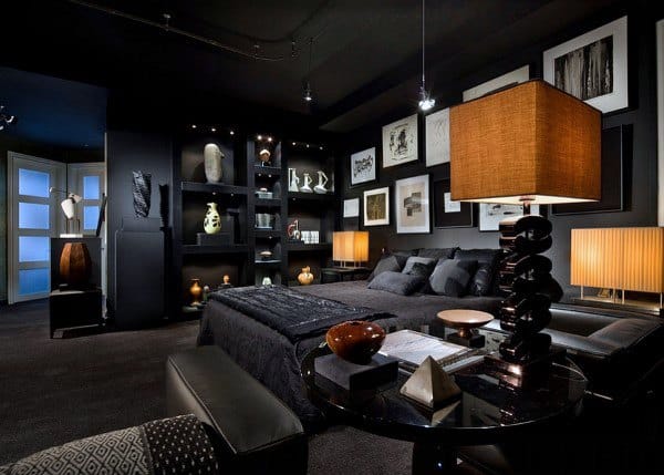 Stylish black bedroom with modern decor, warm lighting, and a gallery wall display.