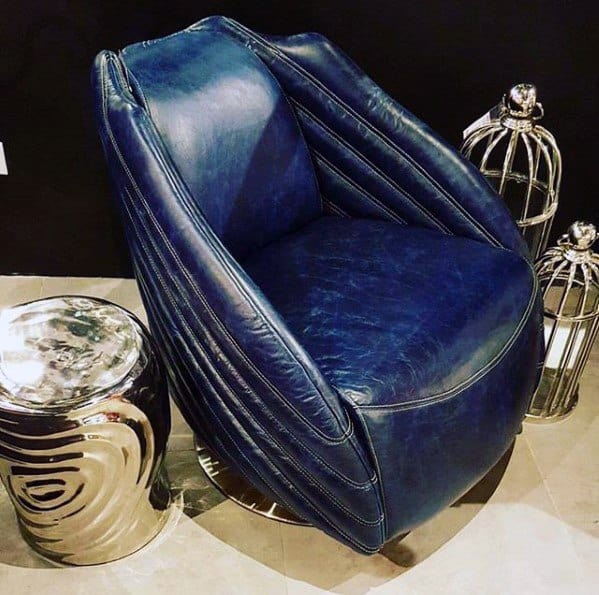 Retro blue leather armchair with chrome side table in a modern decor setup.